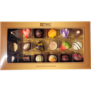 A Gift Box of 18 gourmet chocolates from Poppy's Chocolate, featuring an assortment of handcrafted pieces in various shapes and colors such as hearts, swirls, and stripes, elegantly arranged in a gold-bordered tray. The label proudly states "Handcrafted in Australia.