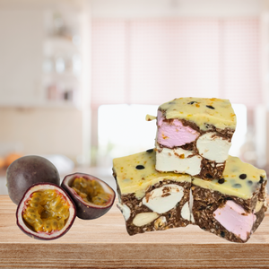 An empty wooden table in front of a kitchen displaying a Passionfruit Rocky Road