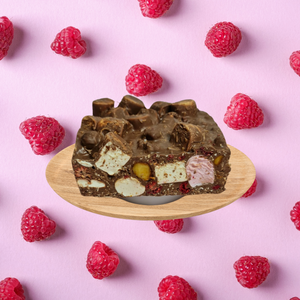 An image of Rocky Road with Raspberry, Macadamia, and Milk Chocolate with raspberry background.