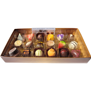 A gift box from Poppy's Chocolate, featuring 18 individually wrapped gourmet chocolates including truffles, all bordered in gold. The chocolates come in a delightful assortment of shapes, colors, and toppings, elegantly arranged in rows to highlight a stunning array of designs and flavors.